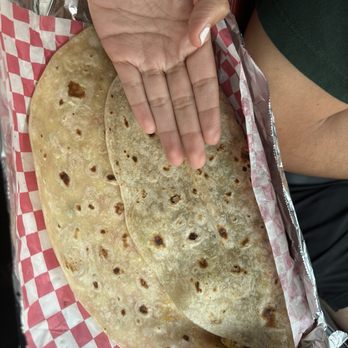 Jenny Delicias - Chorizo and egg taco (hand for scale) - Mexican Near Me - Brownsville, Texas Jenny Delicias - Chorizo and egg taco (hand for scale) - Mexican Near Me - Brownsville, Texas