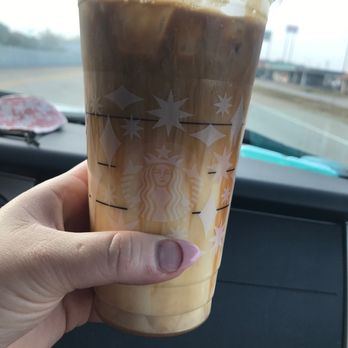 Starbucks - a hand holding a cup of iced coffee - Coffee & Tea Near Me - DeSoto, Texas Starbucks - a hand holding a cup of iced coffee - Coffee & Tea Near Me - DeSoto, Texas