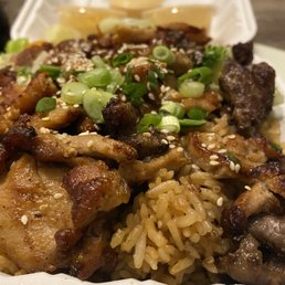 Steak and chicken plate with fried rice and extra yummy sauce Steak and chicken plate with fried rice and extra yummy sauce