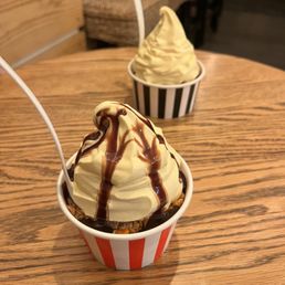  a cup of ice cream with chocolate drizzle