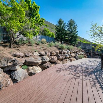 Beavers Septic Service - a wooden deck with a stone wall - Septic Services Near Me