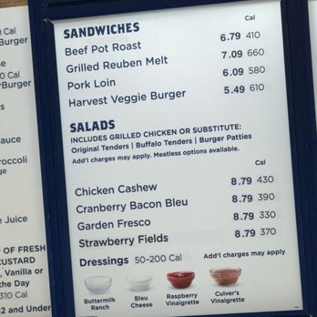 Culver's - The menu board features sections for sandwiches, including Beef Pot Roast, Grilled Reuben Melt, Pork Loin, and Harvest Veggie Burger, with prices and calorie information. It also lists salads with options like Chicken Cashew, Cranberry Bacon Bleu, Garden Fresco, and Strawberry Fields, along with their prices and calories. Dressings are shown at the bottom with images of Buttermilk Ranch, Bleu Cheese, Raspberry Vinaigrette, and Culver's Vinaigrette, with a note that add-ons may apply. The board is framed and mounted on a wall, likely inside a restaurant or cafe. - Burgers Near Me - Springfield, Illinois