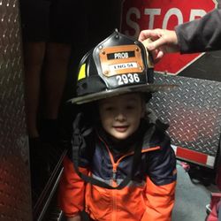 FDNY Engine 54/Ladder 4 - Gavin trying on Fireman Pat's helmet.