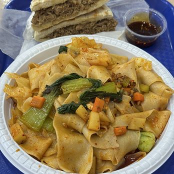 Lao Shan Xi’an Delicacies - C1. Hand-pulled Noodles w/ Sizzling Chili Oil (front), E1. Braised Pork Baiji Bun (back) - Chinese Near Me - Queens, New York Lao Shan Xi’an Delicacies - C1. Hand-pulled Noodles w/ Sizzling Chili Oil (front), E1. Braised Pork Baiji Bun (back) - Chinese Near Me - Queens, New York