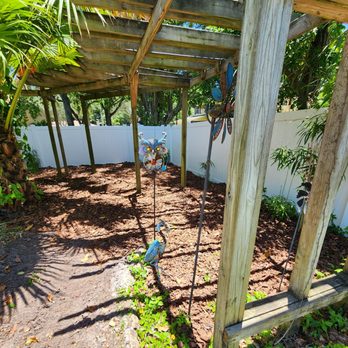 Nieves Lawn Care - a wooden pergolated area - Lawn Services Near Me Nieves Lawn Care - a wooden pergolated area - Lawn Services Near Me