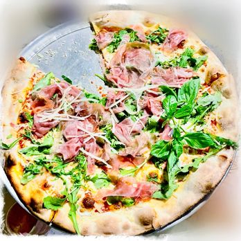 Lucali - a pizza with meat and greens on it - Italian Near Me - Miami Beach, Florida
