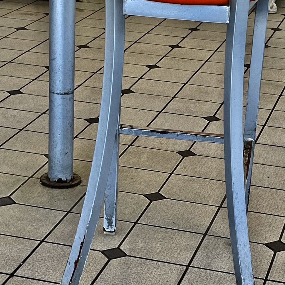 White Castle - an orange chair on a tiled floor - Fast Food Near Me - Camby, Indiana