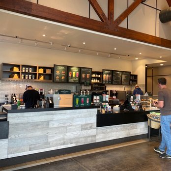 Starbucks - a man standing at the counter of a coffee shop - Coffee & Tea Near Me - Spokane, Washington Starbucks - a man standing at the counter of a coffee shop - Coffee & Tea Near Me - Spokane, Washington