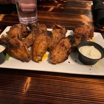 Di Prinzio's Kitchen - Firewood wings.  These were GREAT. Served hot and spiced just right.  Delicious!  Several are missing.  Sorry I couldn't wait. - Cocktail Bars Near Me - Clayton, New York