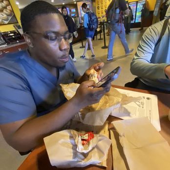 Einstein Bros. Bagels - joel eating while i wait for my food - Breakfast & Brunch Near Me - Orlando, Florida