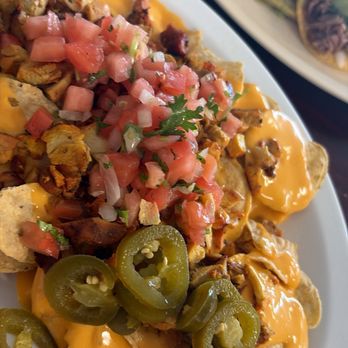 Ponchos Tacos - These are the grilled chicken nachos, they come with sour cream but opted out - Mexican Near Me - Fullerton, California Ponchos Tacos - These are the grilled chicken nachos, they come with sour cream but opted out - Mexican Near Me - Fullerton, California