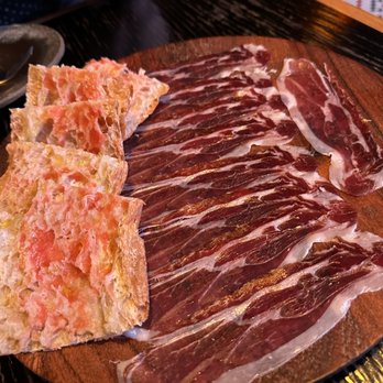 MAD - Jamón Ibérico $35.00 1.5oz acorn-fed iberico de bellota cured ham, pan de cristal, fresh tomato pulp - Spanish Near Me - Houston, Texas MAD - Jamón Ibérico $35.00 1.5oz acorn-fed iberico de bellota cured ham, pan de cristal, fresh tomato pulp - Spanish Near Me - Houston, Texas