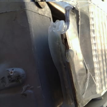 Caliber Collision - Caliber workmanship:  gobs of hot-glue supporting the parking lamp that was never replaced - Body Shops Near Me - Burbank, California