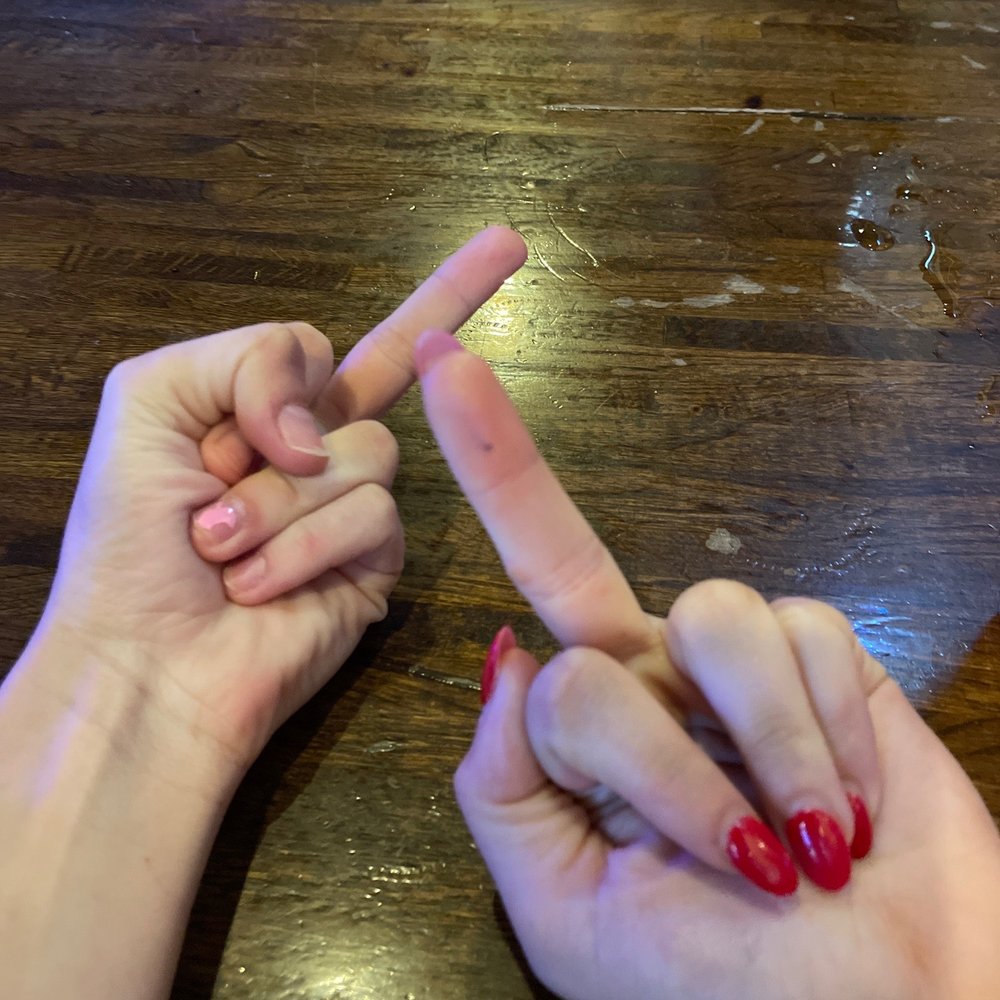 two hands making a sign