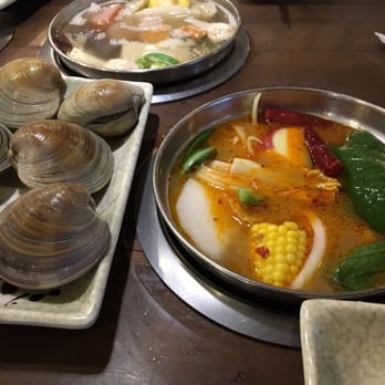 Spring Shabu-Shabu - Spicy pork broth (bottom) and Dashi broth (top) with some clams. - Japanese Near Me - Flushing, New York Spring Shabu-Shabu - Spicy pork broth (bottom) and Dashi broth (top) with some clams. - Japanese Near Me - Flushing, New York