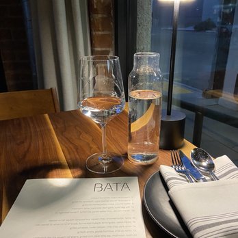 BATA - Love the warm solid wood tables...the low light ambiance is elegant.  Each table has a special table light; neat. - New American Near Me - Tucson, Arizona