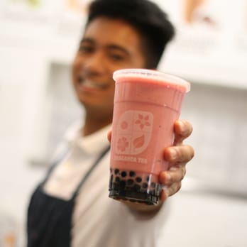 Braganza Tea - a man holding a cup of bubble tea - Bubble Tea Near Me - Portland, Oregon Braganza Tea - a man holding a cup of bubble tea - Bubble Tea Near Me - Portland, Oregon