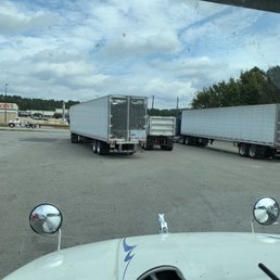 two semi trucks parked in a parking lot two semi trucks parked in a parking lot