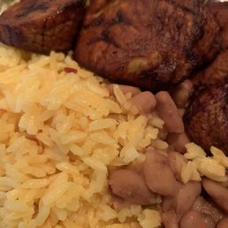Yellow rice and beans topped with plantain slices. (Sometimes plantain served undercooked) Yellow rice and beans topped with plantain slices. (Sometimes plantain served undercooked)