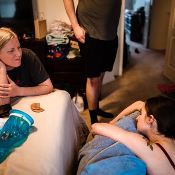 Emergence - Midwife Kayla watching, waiting for baby girl to make her appearance - Midwives Near Me
