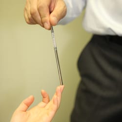 Koyama Chiropractic & Acupuncture Clinic - Color therapy test with patient's middle finger.
