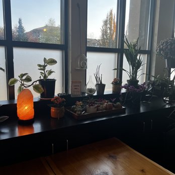 Twins Coffee - a table with a candle and potted plants - Cafes Near Me - Langley, British Columbia Twins Coffee - a table with a candle and potted plants - Cafes Near Me - Langley, British Columbia