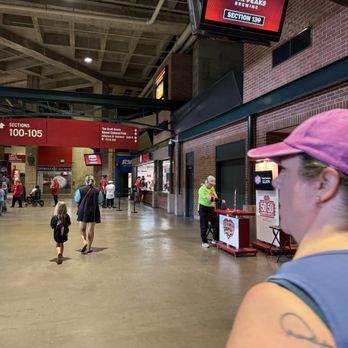 Chase Field - Walking to our seats - Indoor stadium concourse with visitors walking, including a woman in a pink cap and a child, near section 139 and food vendors. - Stadiums & Arenas Near Me - Phoenix, Arizona