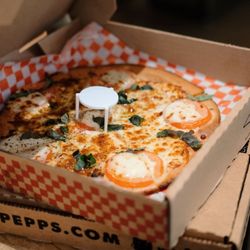 Sgt. Pepperoni's Pizza Store - Our Margherita Pizza: Fresh mozzarella, Roma tomatoes, basil, and garlic.