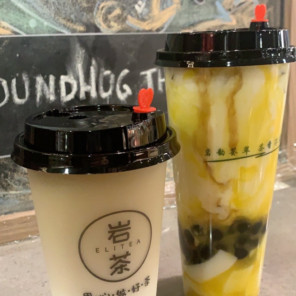 White peach oolong milk tea and mango latte with coconut jelly and boba White peach oolong milk tea and mango latte with coconut jelly and boba