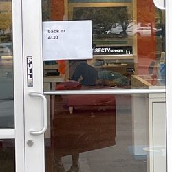 AT&T Store - At 3:30 in the afternoon. Door is locked and employee is laid out on the bench in the store watching a movie on his phone.