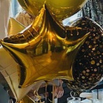 Designer Balloons & Events - A set of balloons at the end of one of the dinner tables - Balloon Services Near Me