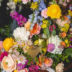 Events By Krissy - A martini and a glass of prosecco in front of a floral arrangement
