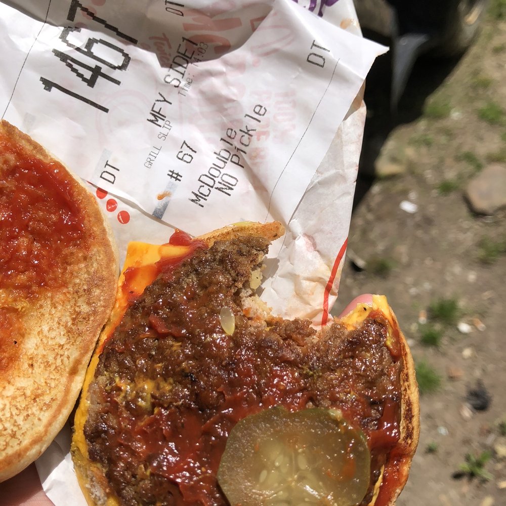 McDonald's - a hand holding a half eaten pizza - Fast Food Near Me - Irvine, Kentucky McDonald's - a hand holding a half eaten pizza - Fast Food Near Me - Irvine, Kentucky