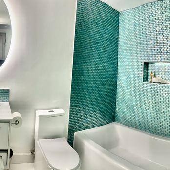 Muir Construction - a bathroom with a sink, toilet, and bathtub - General Contractors Near Me
