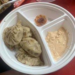 a plate of dumplings and sauce