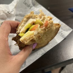 a person holding a sandwich a person holding a sandwich