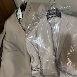 The Wardrobe Modern Menswear - Fiancé suit next to the lighter groomsmen suit