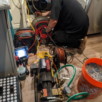 Hyper Flow Service - James working on unclogging our kitchen drainage pipes. - Plumbing Near Me - Denver, Colorado