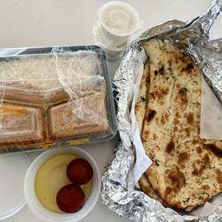 CHICKEN TIKKA MASALA, GARLIC NAAN and Gulab jamun desert. Side of yogurt sauce.