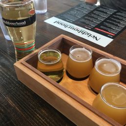a flight of beer in a wooden tray a flight of beer in a wooden tray