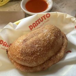 Panzerotti egg and cheese with some hot sauce on the side Panzerotti egg and cheese with some hot sauce on the side