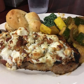 Wolf Bay Restaurant - Foley - NY Strip steak covered in blue cheese, with a side of sauteed vegetables and a garlic knot. - Seafood Near Me - Foley, Alabama Wolf Bay Restaurant - Foley - NY Strip steak covered in blue cheese, with a side of sauteed vegetables and a garlic knot. - Seafood Near Me - Foley, Alabama