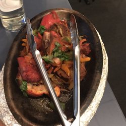Shalimar of India - This is how it was brought. The tongs on the hot sizzling plate.