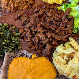 A medley of lentils and veggies including gomen, misir wat, kik alicha, dorowat, shiro wat, and awaze tibs