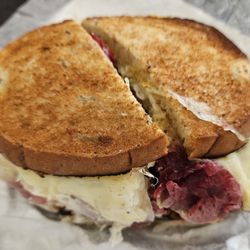 Attman's Delicatessen - Corned Beef, "Extra Heavy +$", regular cut meat, with Sauerkraut, Swiss cheese, with deli mustard, on toasted rye bread.