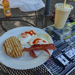 A Walk in the Park Café - Rise and shine with two over medium eggs, bacon, toast, and a fruit smoothie.