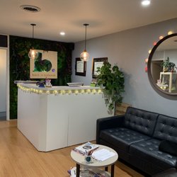 Front desk area. Floor to ceiling moss wall by Planted Design with our logo inside.