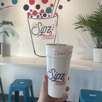 Sipz Sodas - a hand holding a cup of soda - Juice Bars & Smoothies Near Me - Columbia, Missouri