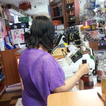Dillon Liquor - a woman at a counter in a liquor store - Beer, Wine & Spirits Near Me - Old River-Winfree, Texas