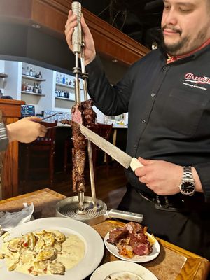 Photo of Charbroil Grill Brazilian Steakhouse - Woodbridge, VA, US. a man holding a knife